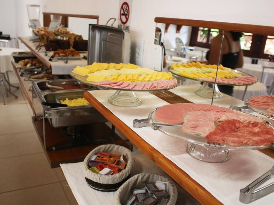 A buffet with various food items including meats and cheeses.