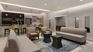 A modern living room with sofas, chairs, a coffee table, and a pool table. - La Quinta Inn & Suites by Wyndham Rock Hill (Rock Hill)