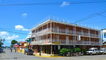 Enjoy outdoor dining or relaxation on the upper-floor balcony with views of the city.