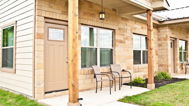 A two-story house with a covered porch, large windows, and a front door. - "The Wedgewood"/A Little Bit Country, Close To Town, New, Clean And Fresh. (Kyle)