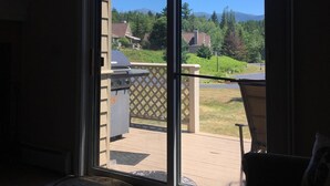 A room with a large sliding glass door leading to a deck. - F23 Awesome on golf course in Bretton Woods with Mountain Views, Roku, AC and Piano! Dog Friendly (Bretton Woods)