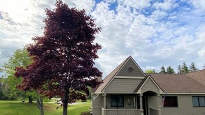 A single-story house with a gabled roof, a front porch, and a small front yard. - F23 Awesome on golf course in Bretton Woods with Mountain Views, Roku, AC and Piano! Dog Friendly (Bretton Woods)