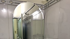 A bathroom with a blue sink, a mirror, and a glass shelf. - Tan An Guest House (Ho Chi Minh City)