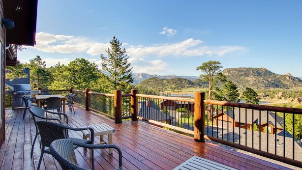 A wooden deck with outdoor furniture, a grill, and a view of a mountainous landscape. - Lake & Mountain Views: Stunning Estes Park Home! (Estes Park)