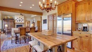 A spacious kitchen with wooden cabinets, a large island, and stainless steel appliances. - Lake & Mountain Views: Stunning Estes Park Home! (Estes Park)
