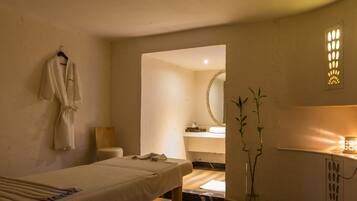 Enjoy a restful stay in this stylish room featuring a comfortable bed, a large mirror, and a convenient bedside table.