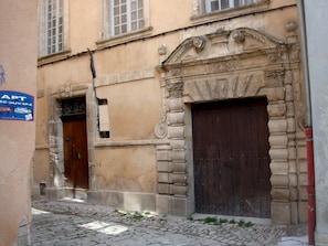 A building with a large wooden door and a stone facade.