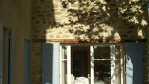A room with a bed, a window, and a door.