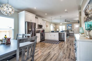 Enjoy cooking in this well-equipped kitchen with a central island, sink, and stainless steel appliances.