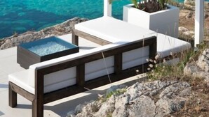 A white canopy over a seating area with a view of a clear blue sea and rocky coastline. - TRULLO WITH POOL SEA VIEW - GALLIPOLI - SOUTH TOWER - JUST RENOVATED (Torre Suda)