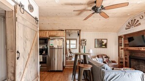 A cozy cabin interior with a kitchen, dining area, and living room. - Guest Cottage,Dog friendly, minutes to Clayton, fenced yard, hot tub on patio. (Tiger)