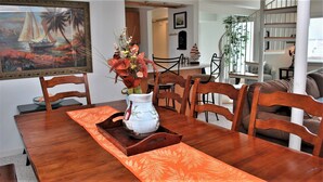 A dining area with a wooden table, chairs, and a vase with flowers. - 3Bed/2Ba Absolutely Beautiful Home just off Prom with Ocean Views (Seaside)