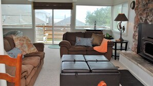 A cozy living room with a brown sofa, a coffee table, and a fireplace. - 3Bed/2Ba Absolutely Beautiful Home just off Prom with Ocean Views (Seaside)