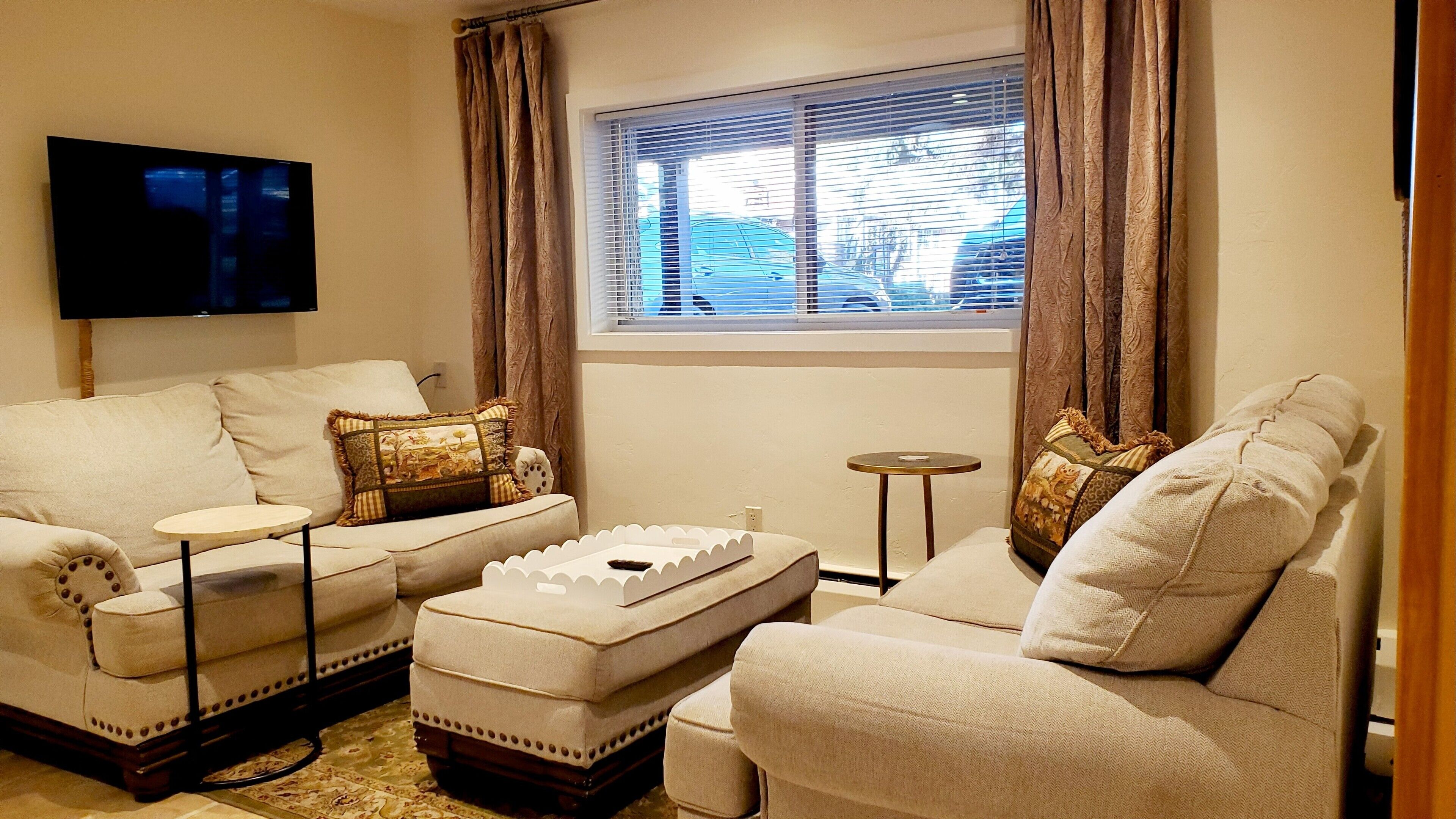 Living room with 2 loveseats and ottoman