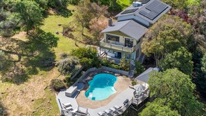 A two-story house with a swimming pool, deck, and a large garden. - A Great Home in a Resort-Like Setting--
Private Retreat with pool & River Views (Valley Springs)