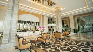 A spacious lobby with a grand staircase, elegant seating, and a decorative ceiling. - The Mira Central Park Hotel (Bien Hoa)
