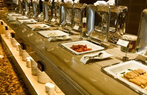 A buffet line with various food items and serving utensils. - The Mira Central Park Hotel (Bien Hoa)
