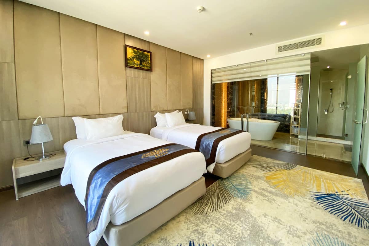 A modern hotel room with two beds, a large window, a bathtub, and a shower.