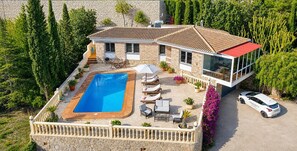 A two-story house with a swimming pool, outdoor seating, and a car parked in front. - La Cofa - Javea, Costa Blanca (Javea)