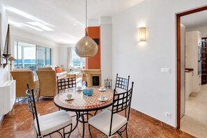 A dining area with a round table, chairs, and a hanging light fixture. - La Cofa - Javea, Costa Blanca (Javea)