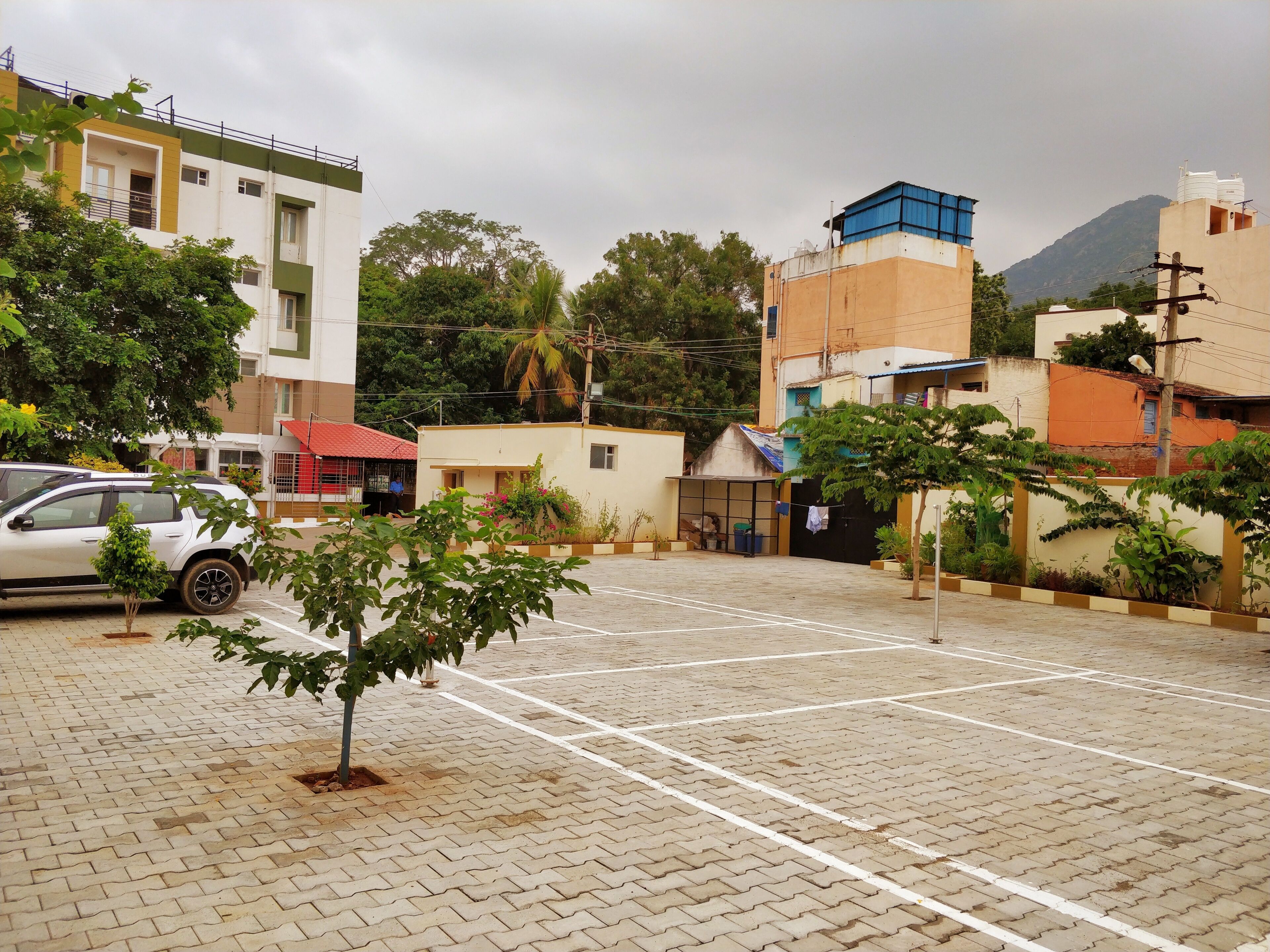 A parking lot with a white car parked on the left.