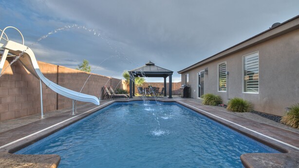 A swimming pool with a slide, lounge chairs, and a gazebo. - STUNNING/IMMACULATE4bd/2ba PrivatePool/WaterSLIDE new beds!!BOOK (Washington)