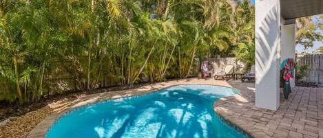 A heated pool, sun loungers