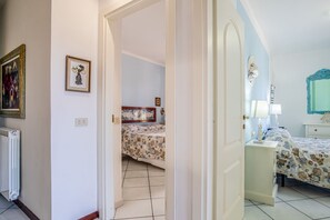 A bedroom with a bed, a nightstand, a dresser, and a mirror. - Villa with private beach access (capoliveri Isola d'Elba)