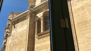 A historic building with classical architecture, featuring a prominent central column and arched windows. -  Light and tranquility in the best location. Destiny Cathedral  (Málaga)