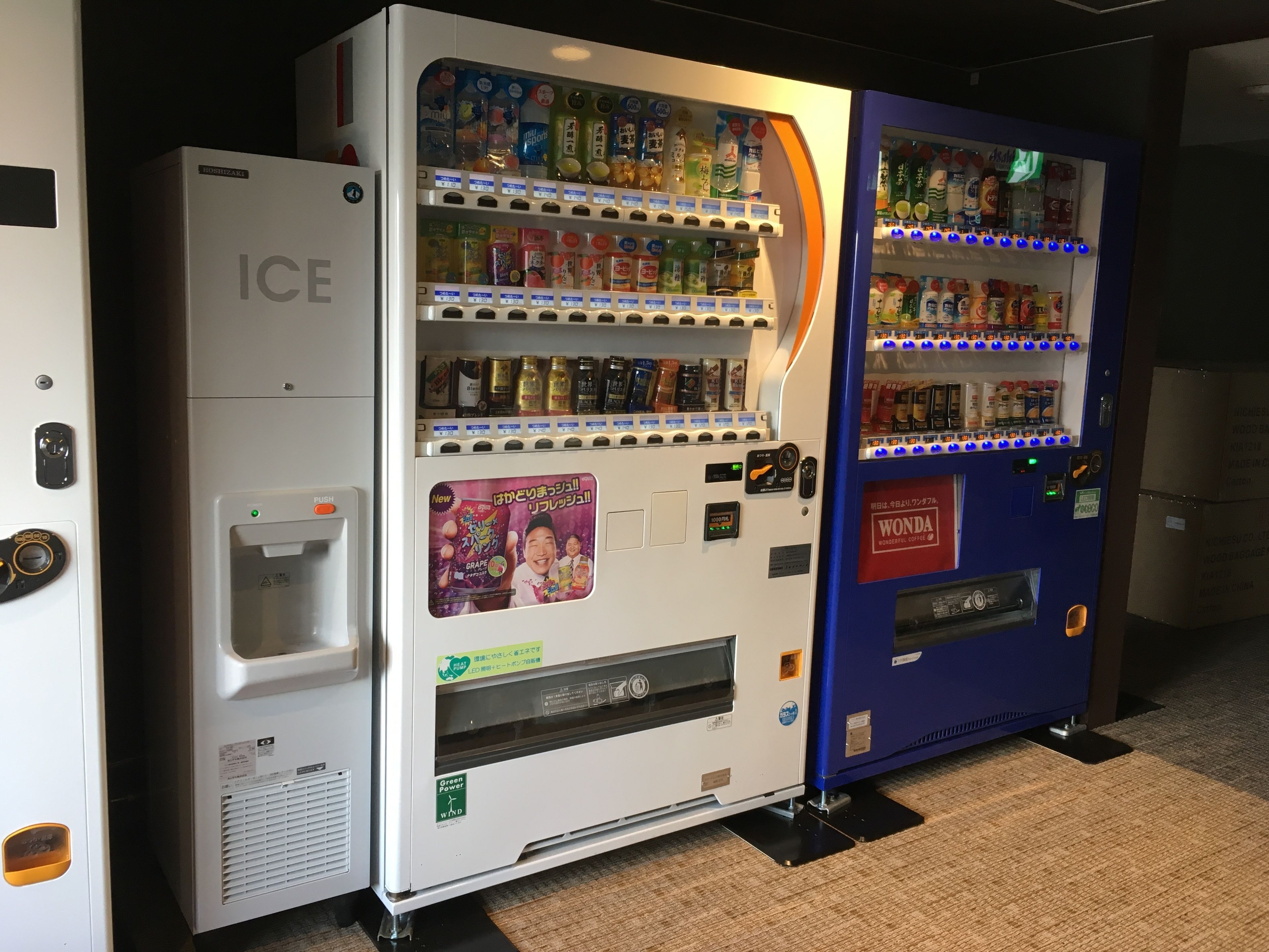 A vending machine with a variety of beverages and snacks, and a separate ice dispenser.
