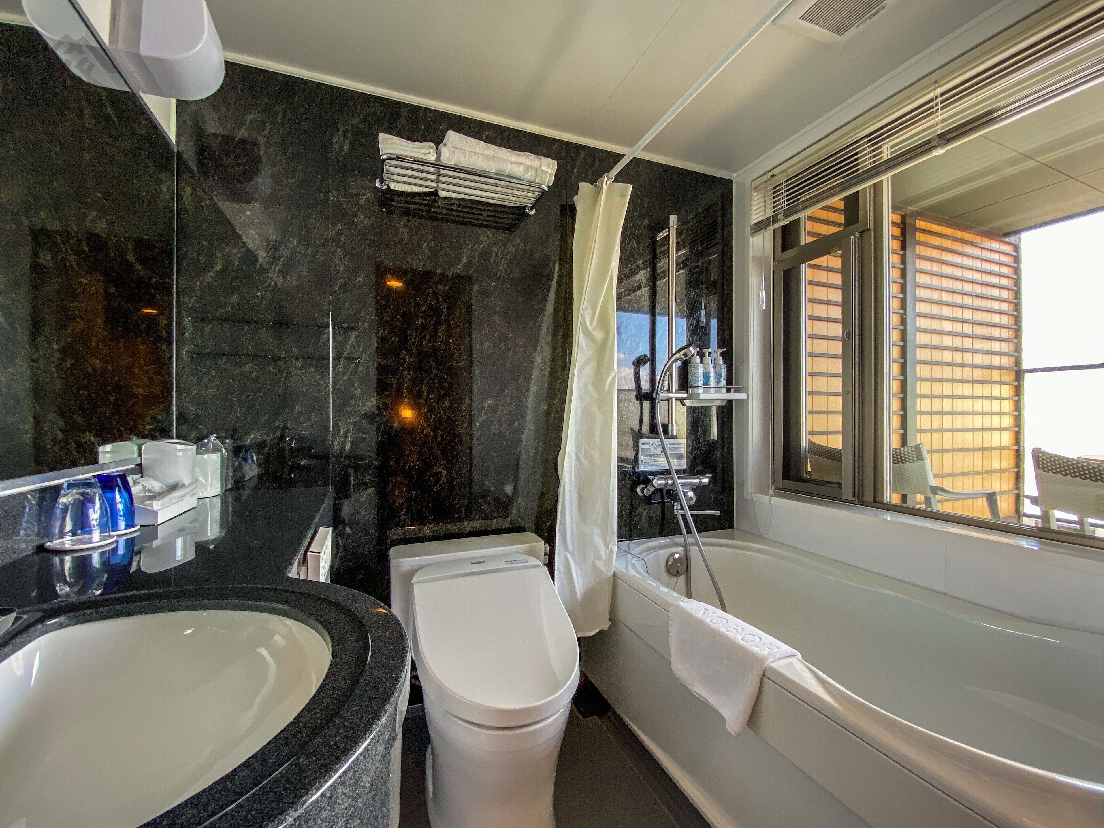 combined shower/bathtub, free toiletries, hair dryer, slippers