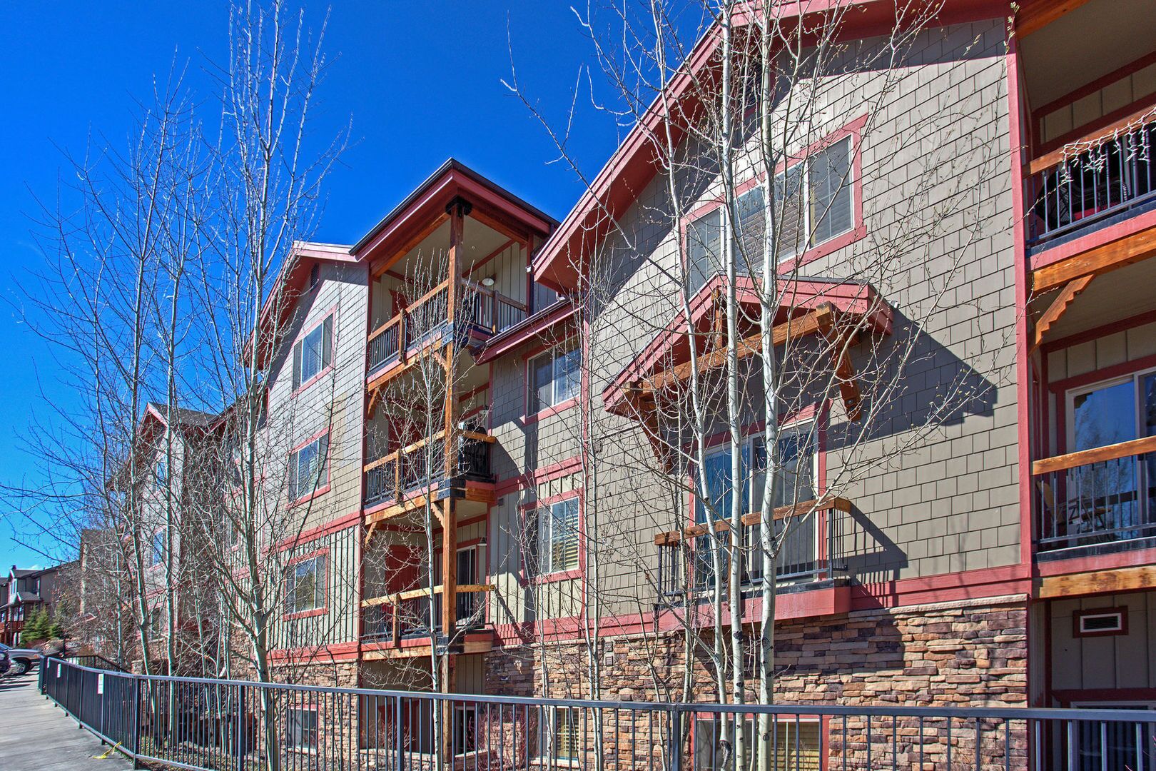 A multi-story building with a brick facade and red accents.