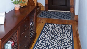 A wooden staircase leading to a dark wooden door with a decorative glass panel. -  Beautiful Victorian Home Close to beaches-Close To Downtown/Shops/Restaurants (Traverse City)