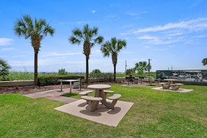 Relax in a serene outdoor setting surrounded by lush greenery and palm trees.
