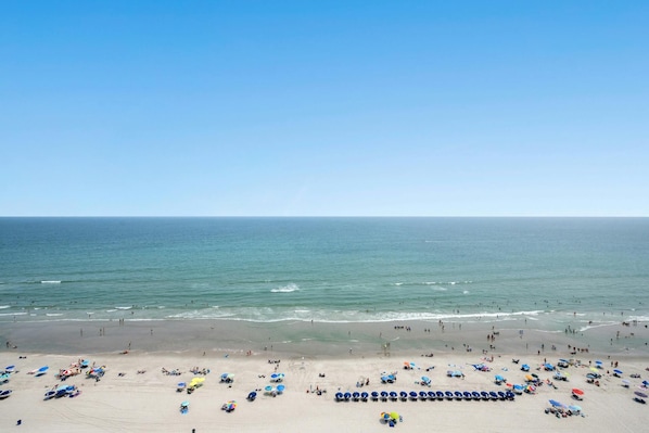 Relax on the beach with comfortable sun loungers and umbrellas, surrounded by calm waters and a serene atmosphere.