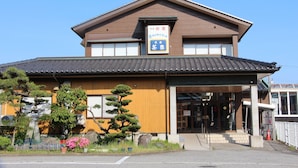 A traditional Japanese building with a sign indicating it is a restaurant. - Tuji Wakuwaku Land Minshuku Chaya (Uozu)