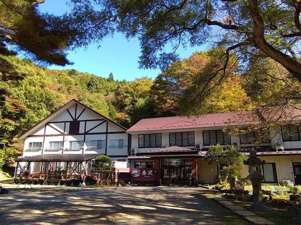 A traditional Japanese-style building with a gabled roof and a covered outdoor seating area. - Akasawa Onsen Ryokan (Nasushiobara)