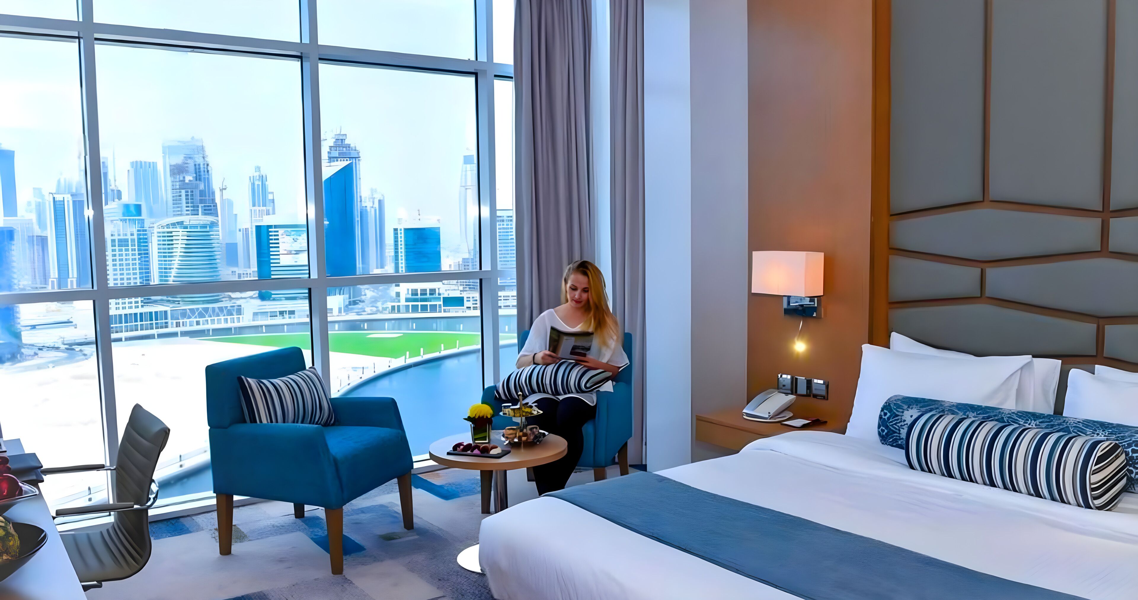 premium room with dubai canal view with free access to hotel's private beach at palm-jumeirah | minibar, in-room safe, desk, soundproofing