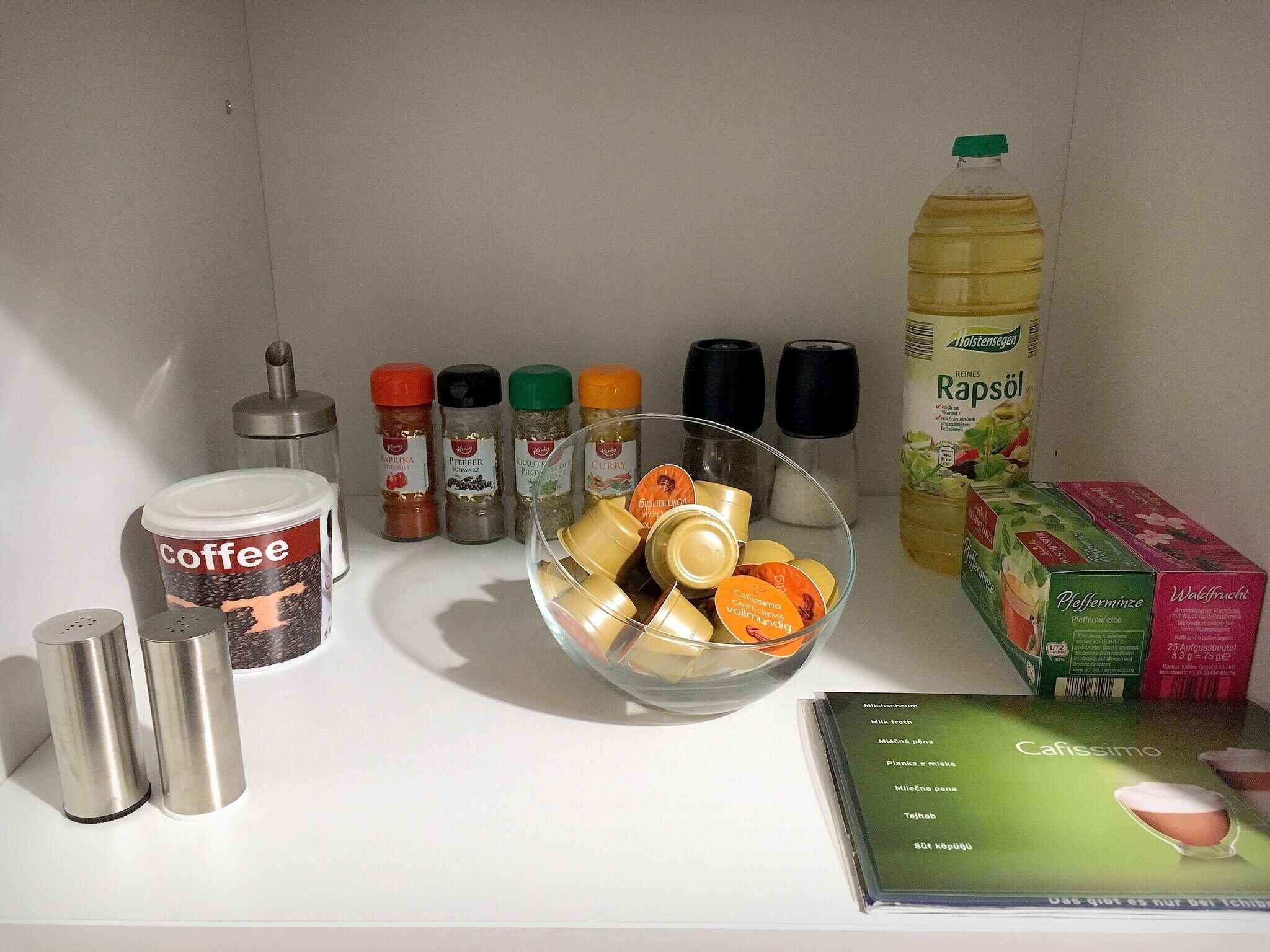 A kitchen counter with various food items and condiments.