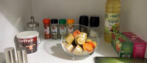 A kitchen counter with various food items and condiments.