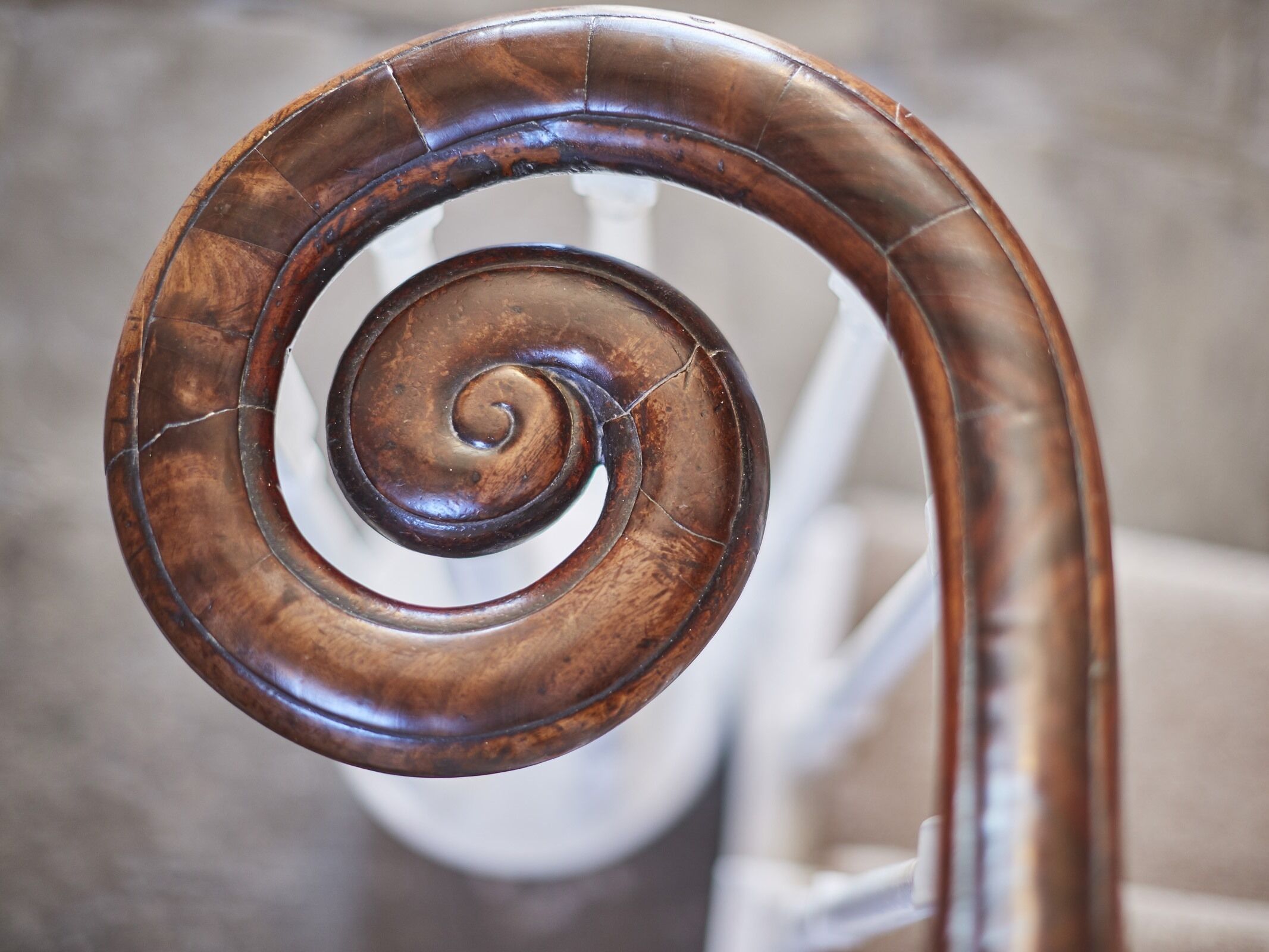A spiral staircase with a wooden handrail.