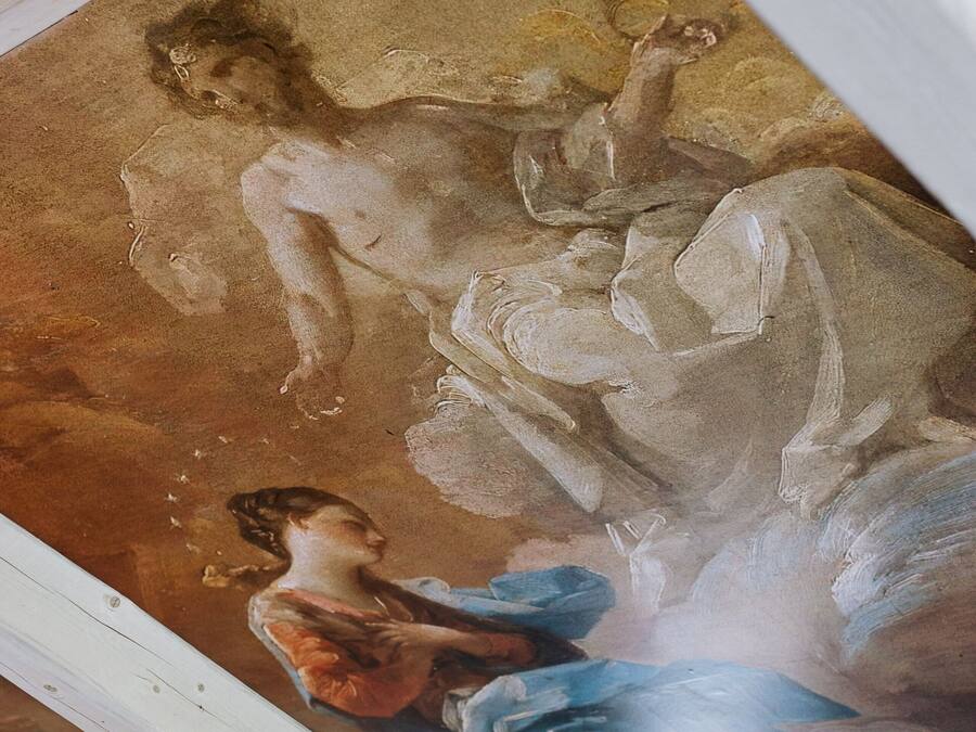 Un fresco en el techo con figuras clásicas y detalles arquitectónicos.
