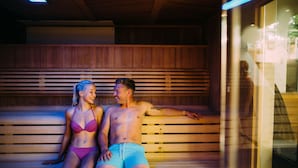 A sauna with wooden benches and a glass partition. - The Spa Hotel at Ribby Hall Village (Preston)
