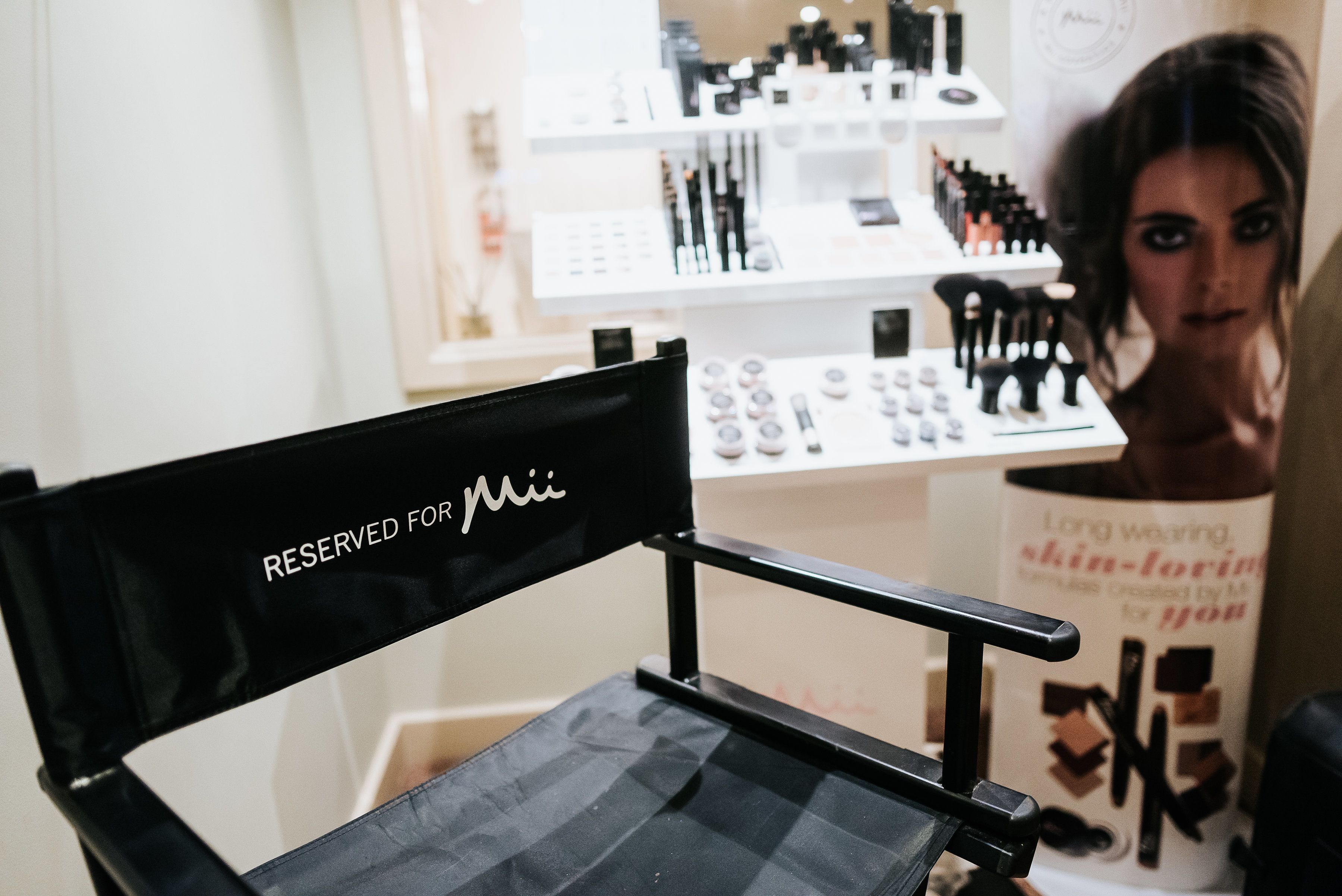 A chair with a sign that reads "RESERVED FOR Mia".