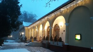 A building with arched windows and a snow-covered ground.