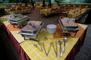 A buffet setup with multiple serving stations, each with a covered food display and serving utensils. - Geréby Kúria Hotel és Lovasudvar (Lajosmizse)