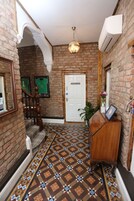 A hallway with a patterned floor, a wooden reception desk, and a door labeled "MANAGER'S LOUNGE."