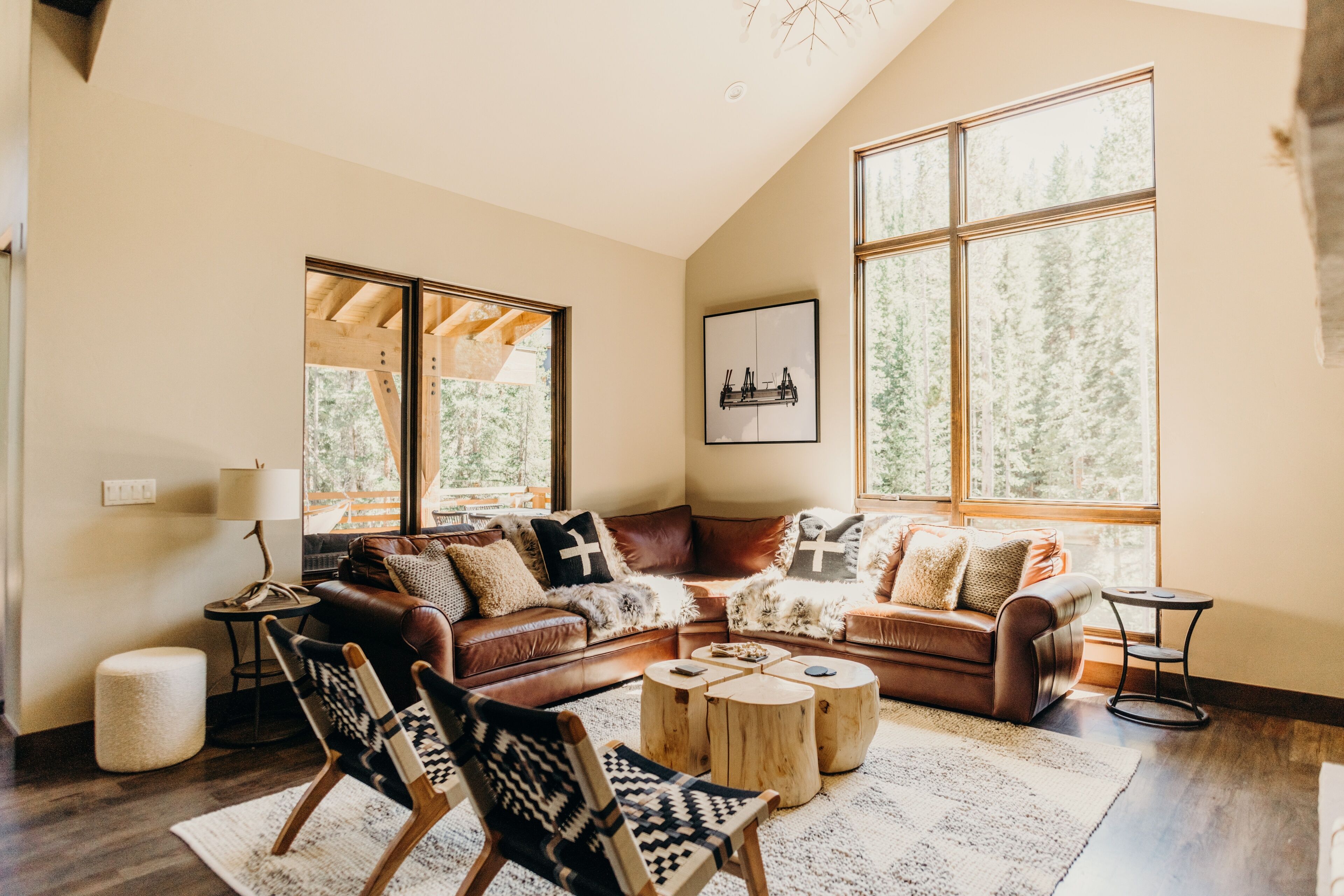 A cozy living room with a brown leather sofa, a patterned armchair, and a wooden coffee table.