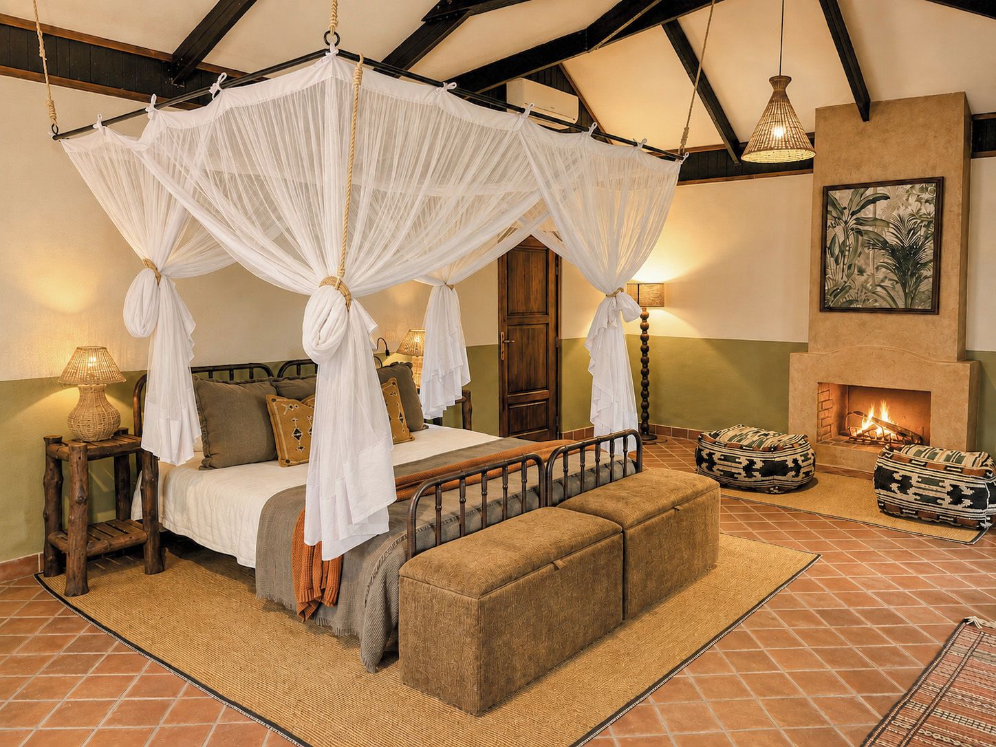 A bedroom with a four-poster bed, a fireplace, and a view of the outdoors.