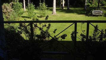 A view of a grassy area with trees and a bench.